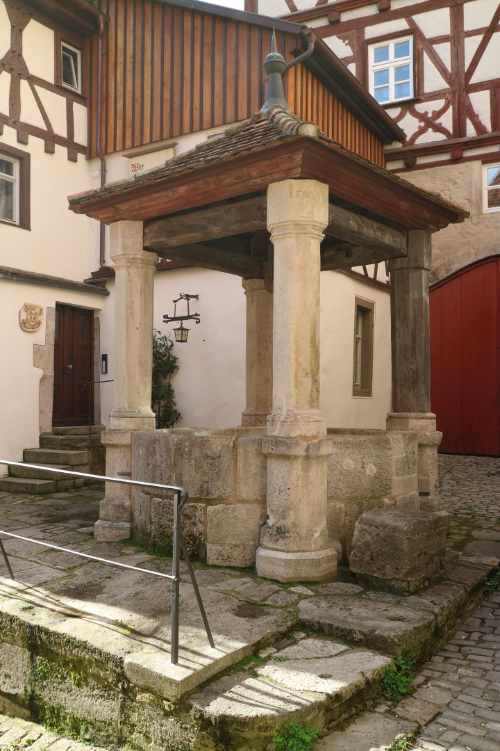 a well in a medieval looking town