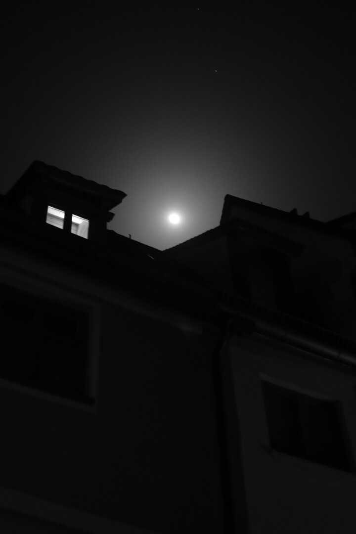 moon between two roofs